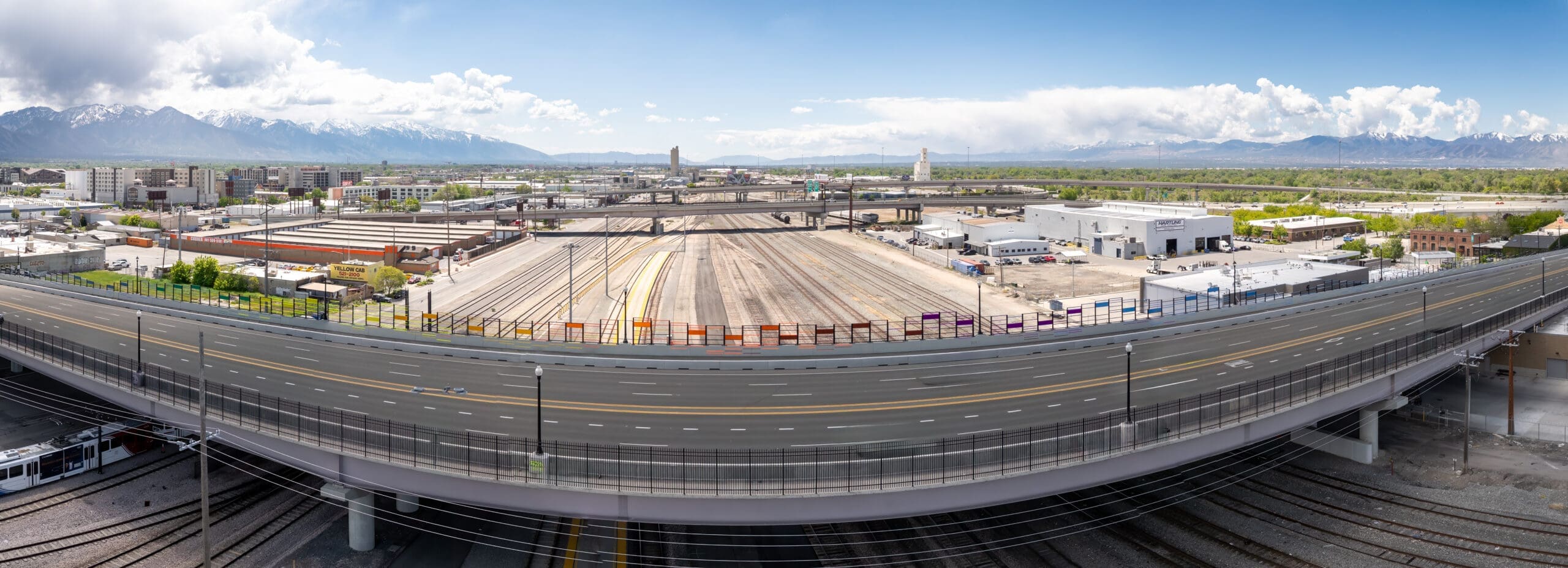 Colored railings along the 400 South Viaduct with mountains beyond